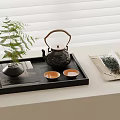 Traditional Tea Set Arrangement With Black Teapot Teacups Green Plant And Tea Leaves