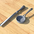 Stainless Steel Kitchen Knife and Measuring Cup with Ergonomic Handles on Wooden Tabletop