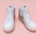 White High Top Shoes Featuring Golden Nike Logo on Pink Background