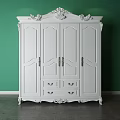 Ornate White Wardrobe With Carved Ornaments Against Green Wall And Functional Bottom Drawers