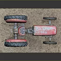Vintage Red Tractor Model Display On Rustic Base With Detailed Wheels And Old Style Design