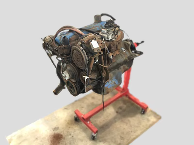 Old Engine on Red Rolling Stand with Mechanical Components Display on Workshop Workbench 3d model