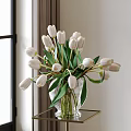 Transparent Glass Vase With White Tulips And Green Leaves On Gold Table