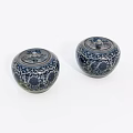 Two Decorative Ceramic Jars With Lids And Blue White Floral Patterns On White Background