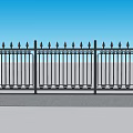 Ornate Black Iron Fence With Pointed Tops Against Blue Sky And Gray Pavement