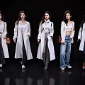 Women wearing white coats with different bottoms against black background in fashion shoot