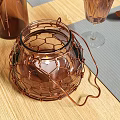 Elegant Dining Table Setup With Leaf Pattern Plates Copper Cutlery And Glass Cups
