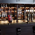 Luxurious Bar Interior With Wooden Counter Wine Racks And Beer Taps