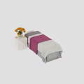Comfortable Massage Bed With Pink And White Sheets And Orange Flowers On Bedside Table