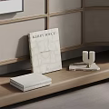 Kerry Joyce Interiors Book On Wooden Surface With Decorative Candle Holder And Light Cabinet