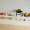 Fresh Assorted Fruits Display on White Countertop with Black Stand Bowls and Wooden Floor