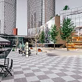 Tall Modern Commercial Street with Glass Facade Buildings Francesca's Coffee Checkerboard Plaza and Green Trees
