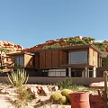 Modern Detached Villa in Desert Rocky Landscape with Large Windows Terrace and Greenery