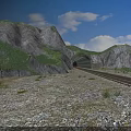 Railway Track Leading To Mountain Tunnel With Green Hills And Blue Sky