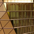 Modern Commercial Complex With Spiral Design And Diamond Shaped Glass Facade Against Sunset Sky