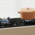 Black Gas Stove With Blue Flames And Orange Pot With Lid In Kitchen