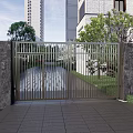 Modern Metal Entrance Gate With Stone Walls Trees And High Rise Buildings
