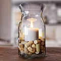 Transparent Glass Candle Lamp With Lit White Candle And Cork Decorations On Wooden Tabletop