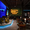 TOMO Friends Festival Bar Interior with Neon Lights Whale Screen Live Music and Dining Tables