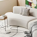 Beige Curved Sectional Sofa With Pillows And Striped Blanket On Area Rug With Wooden Wall