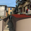 Narrow Alley In Old Residential Area With Red Roof And Hanging Clothes