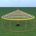 Colorful Striped Circular Photo Spot With Pillars On Green Grass Under Blue Sky