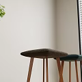 Padded Bar Stools In Dark Green And Brown With Wooden Legs Indoor Near Green Plants
