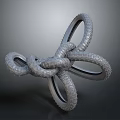 Decorative Metal Knot Ornament With Intertwined Rings And Textured Surface Design