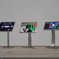 Three Standing Touchscreen Displays Showing Various Content With Wooden Floor And White Wall