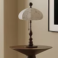 Vintage Table Lamp with White Floral Pattern Shade and Wooden Base on Round Side Table
