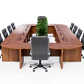 Wooden Office Desk With Black Gray Office Chairs And Green Plants On Tabletop