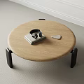 Modern Round Wooden Coffee Table With Black Headphones Stacked Books And Tablet