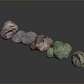 Natural Stone And Wood Decorative Pieces Arranged In A Line On Dark Reflective Surface