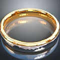 Gold Ring With Diamond Cut Texture And Shiny Metallic Finish On Black Background
