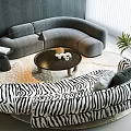 Curved Gray and Zebra Print Sofa Set with Round Coffee Table and Plant