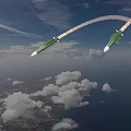 Green Missiles Flying In Blue Sky With Trailing Smoke And Clouds Over Ground