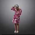 Pink Floral Bath Robe With White Towel On Head Standing Against Gray Background
