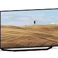 Modern TV Screen Displaying Golden Wheat Field With Single Tree Flying Birds And Blue Sky