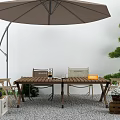 Wooden Outdoor Table With Umbrella Chairs Decorative Plants And Patio Setting