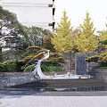 Residential Landscape With Bird Sculpture Water Feature Green Trees And Modern Building Stone Walls