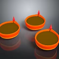 Sculpture Carving Artistic Oil Lamps With Orange Bodies Red Wicks On Black Reflective Surface