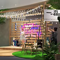 Female Singer Performing On Stage With Wooden Backdrop Neon Sign Guitar Speakers And String Lights