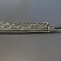 Ornate Decorative Metal Weapon with Intricate Carved Patterns on Blade and Handle