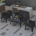 Black Outdoor Lounge Chairs With Side Table And Fruit On Patio Gray Tile Floor