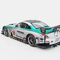 Nissan White And Teal Racing Car With Rear Wing And Sponsor Logos