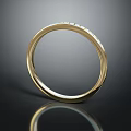 Elegant Gold Ring Set With Small Diamonds On Dark Background With Reflection