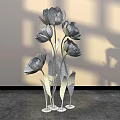 Floral Display With Pink Tulips Green Stems And Metal Bases On Gray Floor
