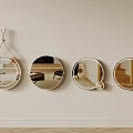Four Round Mirrors With Various Designs Hanging On Light Colored Wall Reflecting Interior Elements