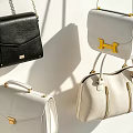 Stylish Black And White Handbags With Crossbody Straps And Structured Designs