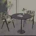 Stylish Black Round Dining Table Set With Patterned Chairs And Vase On Wooden Floor